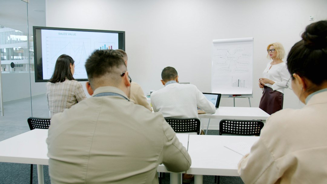 Adult facilitator leading a professional training workshop with a group of participants